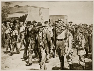 El último ataque a Mafeking: Policía de B.S.A. escoltando prisioneros bóer a la cárcel, de material suministrado por el Mayor F.D. Baillie, Corresponsal Especial del 